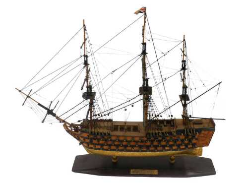 A late model of HMS Victory, with realistic decking and masts, on titled base, 39cm high.