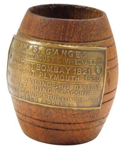 A teak barrel, with metal plaque reading HMS Ganges, later Tenedos III Indusv and Impregnable...
