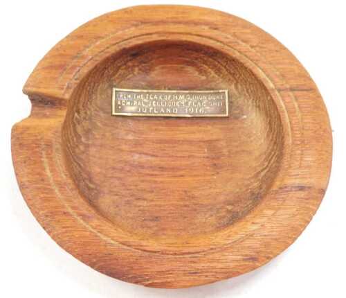 An early 20thC teak ash tray, with metal plaque from the teak of HMS Ironduke Admiral Jellicoe...