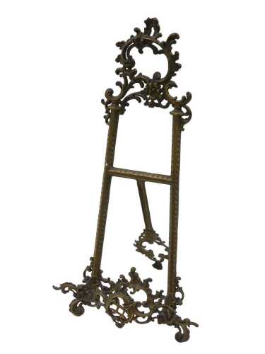 A 20thC brass rococo style table easel, with H back, surmounted by scrolls and flowers, fronted...