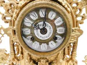 A 20thC gilt metal clock garniture, the 9cm diameter raised enamel Roman numeric dial housed in... - 2