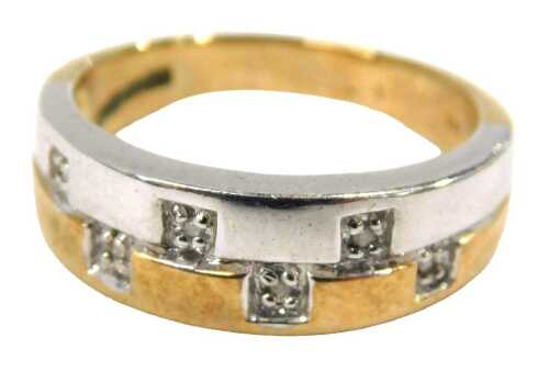 A 9ct gold bicolour dress ring, in white and yellow metal, set with six panels each with tiny...