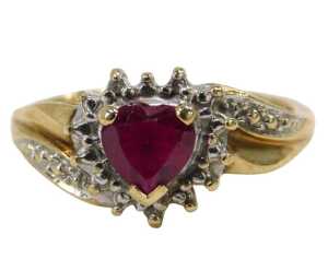 A 9ct gold cluster ring, the heart shaped garnet surrounded by white metal frame, on a yellow...