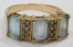 A 9ct gold dress ring, set with rectangular cut aquamarines and six round brilliant cut pale... - 2