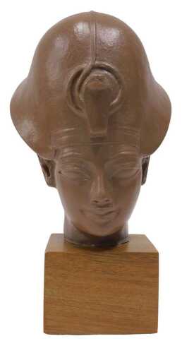 A model of Tutankhamun's head, mounted on a wooden plinth, 34cm high.