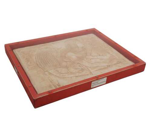 An Egyptian-style relief moulded tomb decoration, in a Perspex and pine display case, 47cm high,...