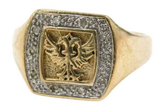 A 9ct gold dress ring, the square set panel with double headed eagle, surrounded by tiny diamond...