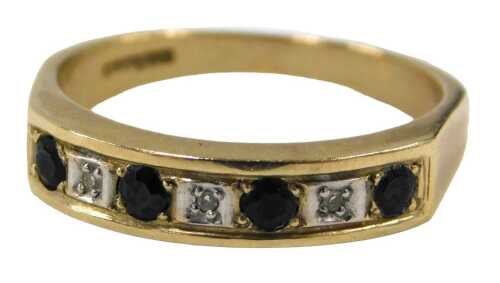 A 9ct gold half hoop dress ring, set with four sapphires and three czs, on a shaped band, ring...