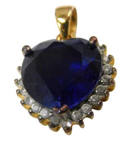 A heart shaped pendant, set with blue and white paste stones, claw set, in a gold plated frame,...