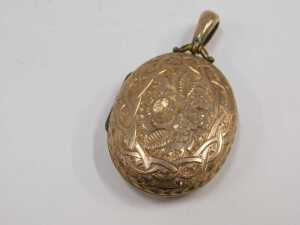 An early 20thC rolled gold locket, heavily engraved with flower and leaf detail, with a pendant... - 2