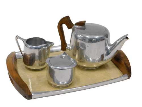 A Picquotware four piece part service, comprising tray, 42cm wide, teapot, sugar bowl and milk...
