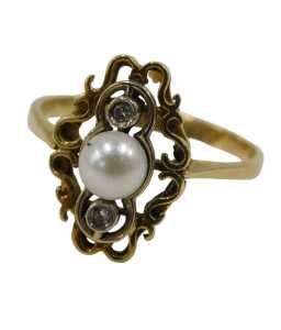 A pearl and diamond dress ring, the central pearl flanked by two tiny diamonds in a platinum Art...