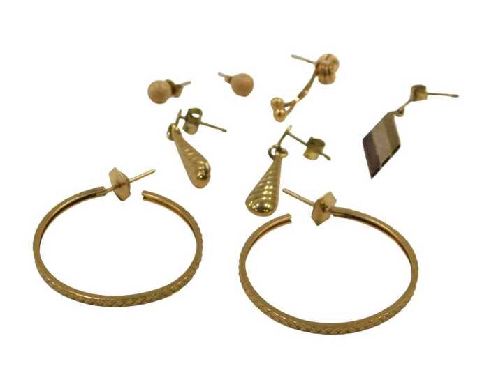 A group of 9ct gold and other earrings, comprising a pair of hammered hoops, a pair of brushed...