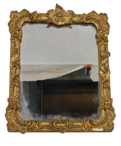 A 19thC gilt gesso small rectangular wall mirror, the frame decorated with scrolls, 29cm x 22cm...