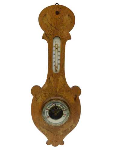 An early 20thC oak and marquetry aneroid barometer and thermometer, in shaped case, 60cm high.
