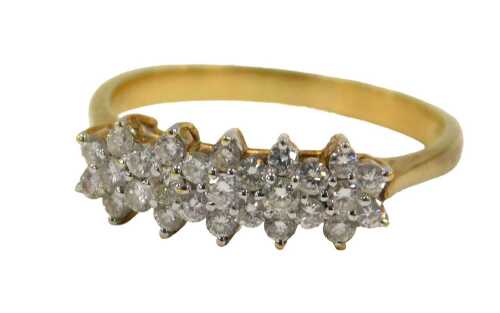 A diamond cluster ring, the ring head set with five floral clusters, each set with tiny diamonds,...