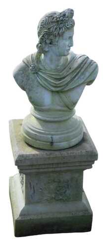 A stone statue of Apollo, on a circular base and associated plinth, 99cm high.