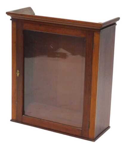 An early 20thC mahogany hanging cupboard, with front glazed door and fixed cornice, 70cm high,...