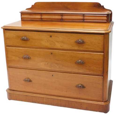 A Victorian mahogany dressing chest, the shaped back with cushion drawers, raised above three...