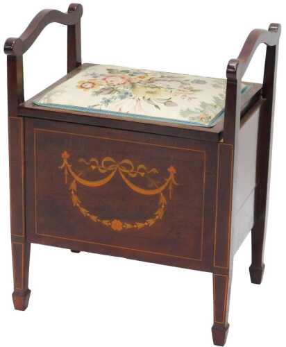 An Edwardian mahogany piano stool, with scroll handles, overstuffed seat, with hinged lid...