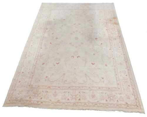 A Pakistani Afghan Sotock Chubi wool pile carpet, in floral pattern, red and cream, 360cm x 278cm.