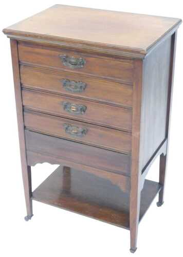 An Edwardian walnut music Canterbury, with four drawers, on square legs terminating in castors,...