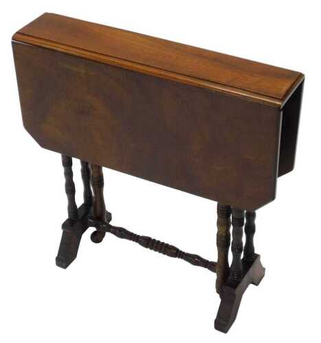 An Edwardian walnut Sutherland table, of small proportion, the canted top raised on turned legs...