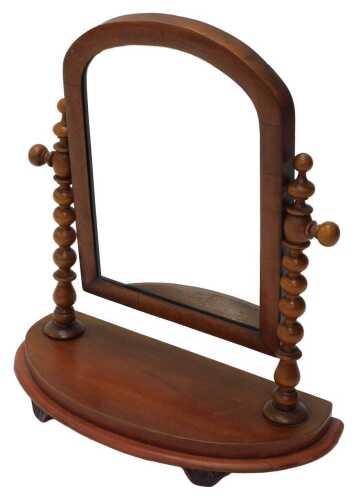 A Victorian mahogany table mirror, the arched glass flanked by barley twist columns, on a D end...