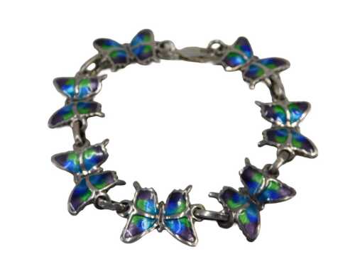 A Mexican butterfly bracelet, formed as seven butterflies, each enamel decorated, white metal...