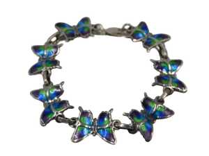 A Mexican butterfly bracelet, formed as seven butterflies, each enamel decorated, white metal...