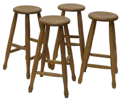 A set of four 20thC beech and elm bar stools, with circular tops, on turned cylindrical legs...