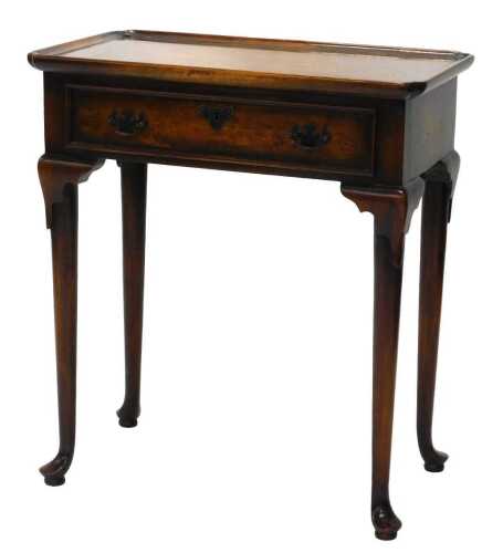 A 20thC Titchmarsh and Goodwin style side table, with moulded top raised above a frieze drawer,...
