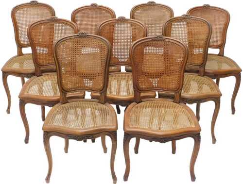 A set of nine early 20thC French oak bergere salon chairs, with shaped backs surmounted by...