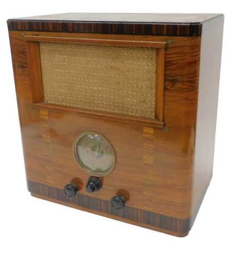 A mid 20thC walnut cased Alba radio, with Lily Road Limited label, number 573321 6791B. WARNING!...