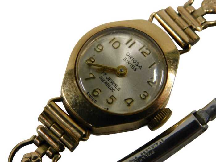 A 9ct gold cased Oriosa lady's wristwatch, with a silvered numeric dial, on a gold plated strap,...