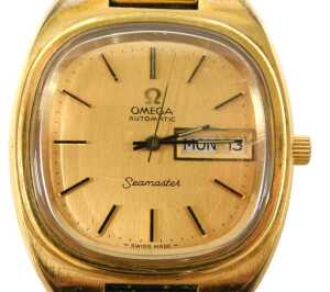 An Omega Seamaster automatic gent's wristwatch, with a gold coloured baton dial and date and day...