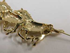 A horse bar brooch, formed as three galloping horses, with a plated gold coloured finish stamped... - 2