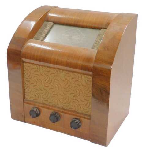 A mid 20thC walnut cased GEC valve radio, in a shaped case, 40cm high. WARNING! This lot...
