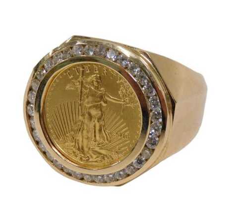 A gentlemen's signet ring, set with 24ct gold Liberty coin, dated 2016, surrounded by a border...