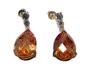 A pair of silver drop earrings, each with an orange/red teardrop cut pendant stone and three...