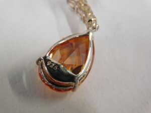 A pair of silver drop earrings, each with an orange/red teardrop cut pendant stone and three... - 2