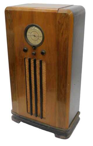 A mid 20thC walnut cased freestanding Pilot radio, with circular dial and material speaker,...