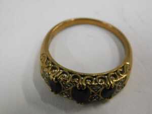 A 9ct gold garnet and diamond half hoop dress ring, set with three oval cut garnets each claw... - 2