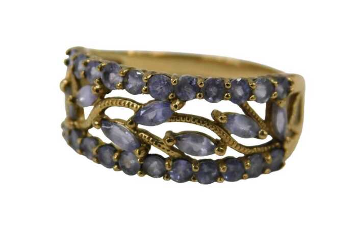 A 9ct gold dress ring, set with pale purple stones, with vine design centre, and round brilliant...