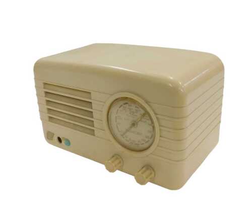 A mid 20thC ivory coloured Bakelite Champion Electric Corp model TRP782 radio, 15cm high....
