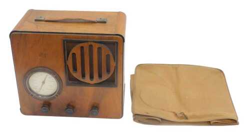 A mid 20thC walnut cased radio, in outer canvas cover, 27cm high. WARNING! This lot contains...