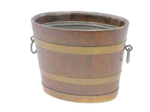 A late 19thC oak coopered jardiniere or barrel, with removable liner and ring handles, 25cm high.