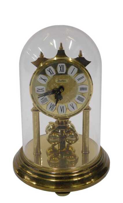 A 20thC Haller anniversary clock, with 8cm diameter dial on turned pillars, in domed case, 20cm...