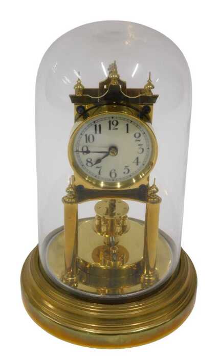 A 20thC brass anniversary clock, the 7cm diameter face in architectural case, on turned pillars,...