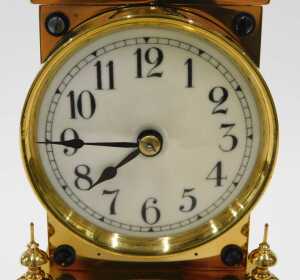 A 20thC brass anniversary clock, the 7cm diameter face in architectural case, on turned pillars,... - 2